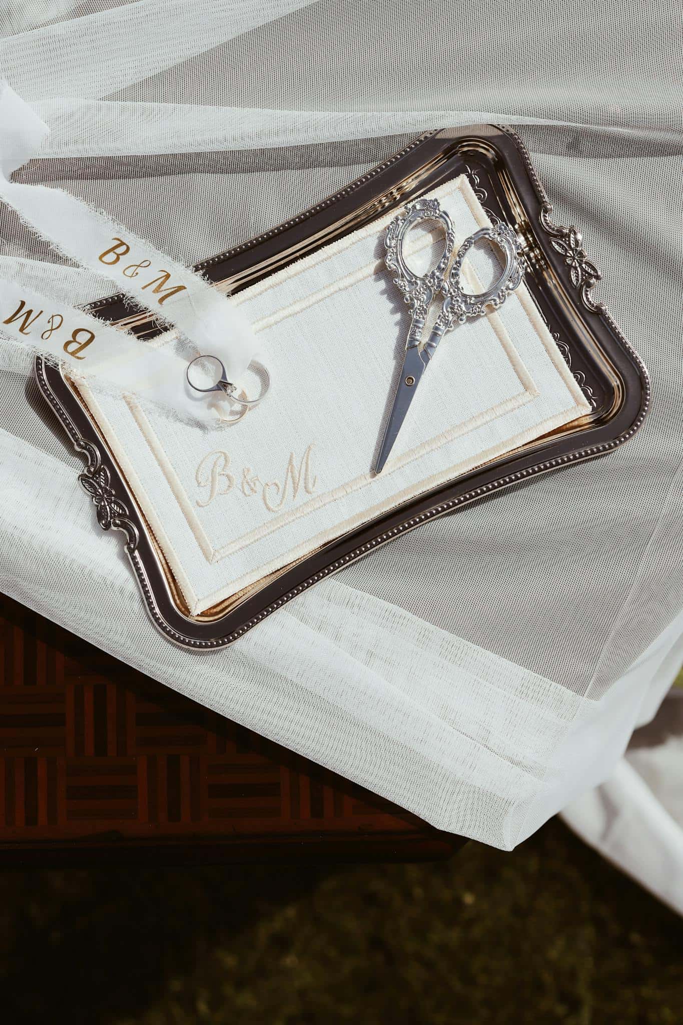 Elegant wedding invitation set with monogram B&M on a silver tray.
